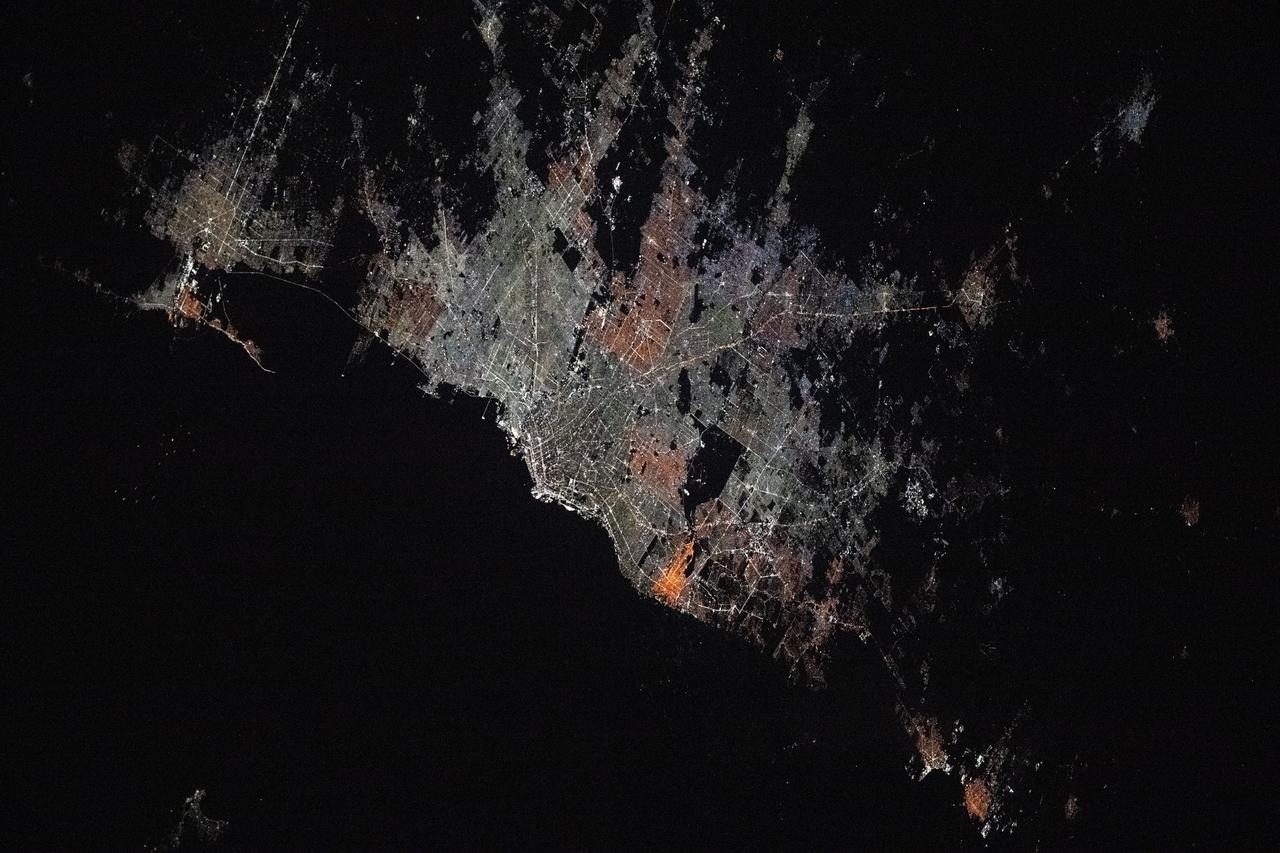 iss073e0176332 (May 20, 2025) --- The Argentinian cities of La Plata (top left) and Buenos Aires and their surrounding suburbs with a combined population of about 13.66 million are pictured at approximately 4:43 a.m. local time from the International Space Station as it orbited 267 miles above.