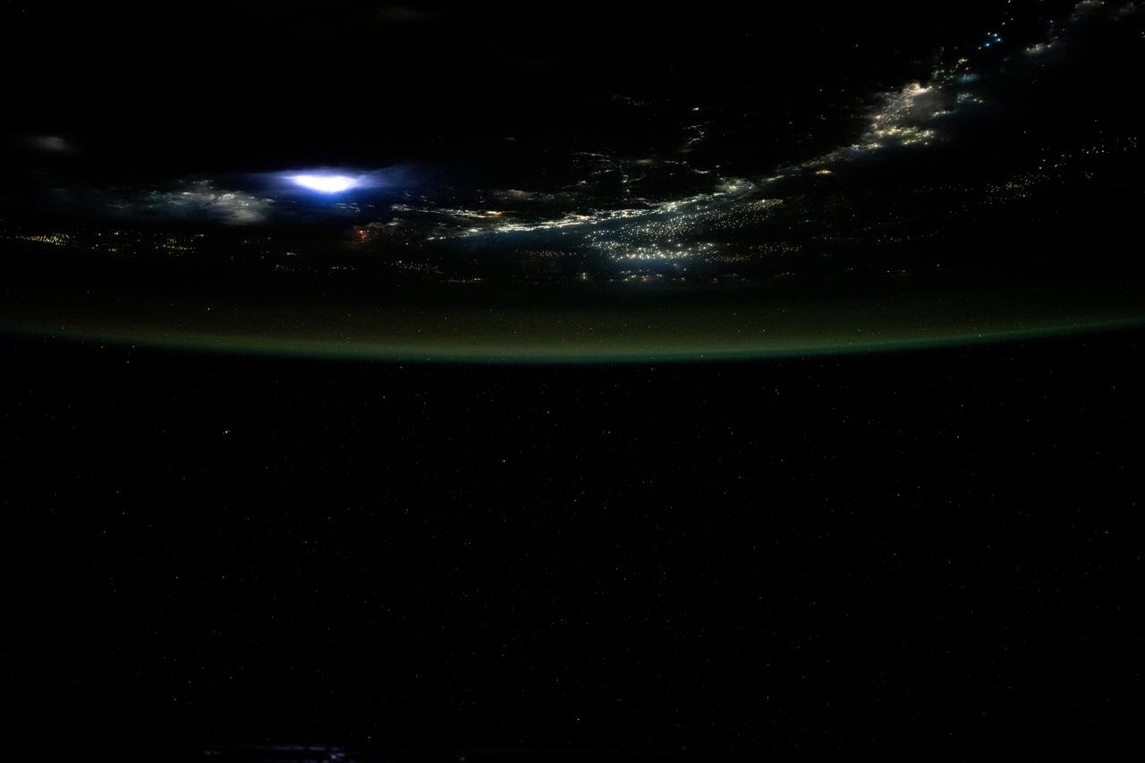 iss073e0204297 (May 25, 2025) --- Lightning illuminates the clouds (left), city lights line the coast of Vietnam, and lights on fishing boats dot the South China Sea in this photograph from the International Space Station as it orbited 259 miles above Southeast Asia.