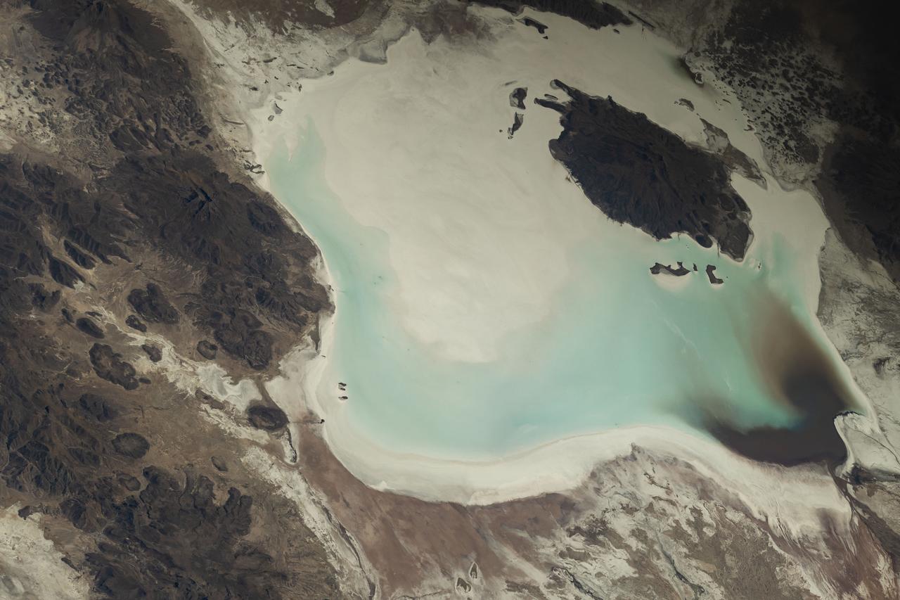 iss073e0248069 (June 24, 2025) --- Lake Coipasa, a basin created by tectonic activity with a high salt concentration surrounded by the Coipasa Salt Flats, in Bolivia near the border with Chile is pictured from the International Space Station as it orbited 264 miles above South America. The volcano Wila Pukarini (upper right) is located inside the lake.