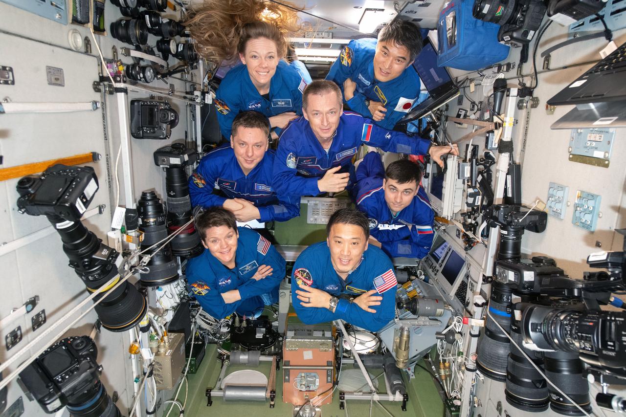 iss073e0249083 (June 15, 2025) --- The seven-member Expedition 73 crew poses for a portrait inside the International Space Station's Zvezda service module. Clockwise from top left are, NASA Flight Engineer Nichole Ayers; JAXA (Japan Aerospace Exploration Agency) Commander Takuya Onishi; Roscosmos Flight Engineer Alexey Zubritsky; NASA Flight Engineers Jonny Kim and Anne McClain; and Roscosmos Flight Engineers Kirill Peskov and Sergey Ryzhikov.