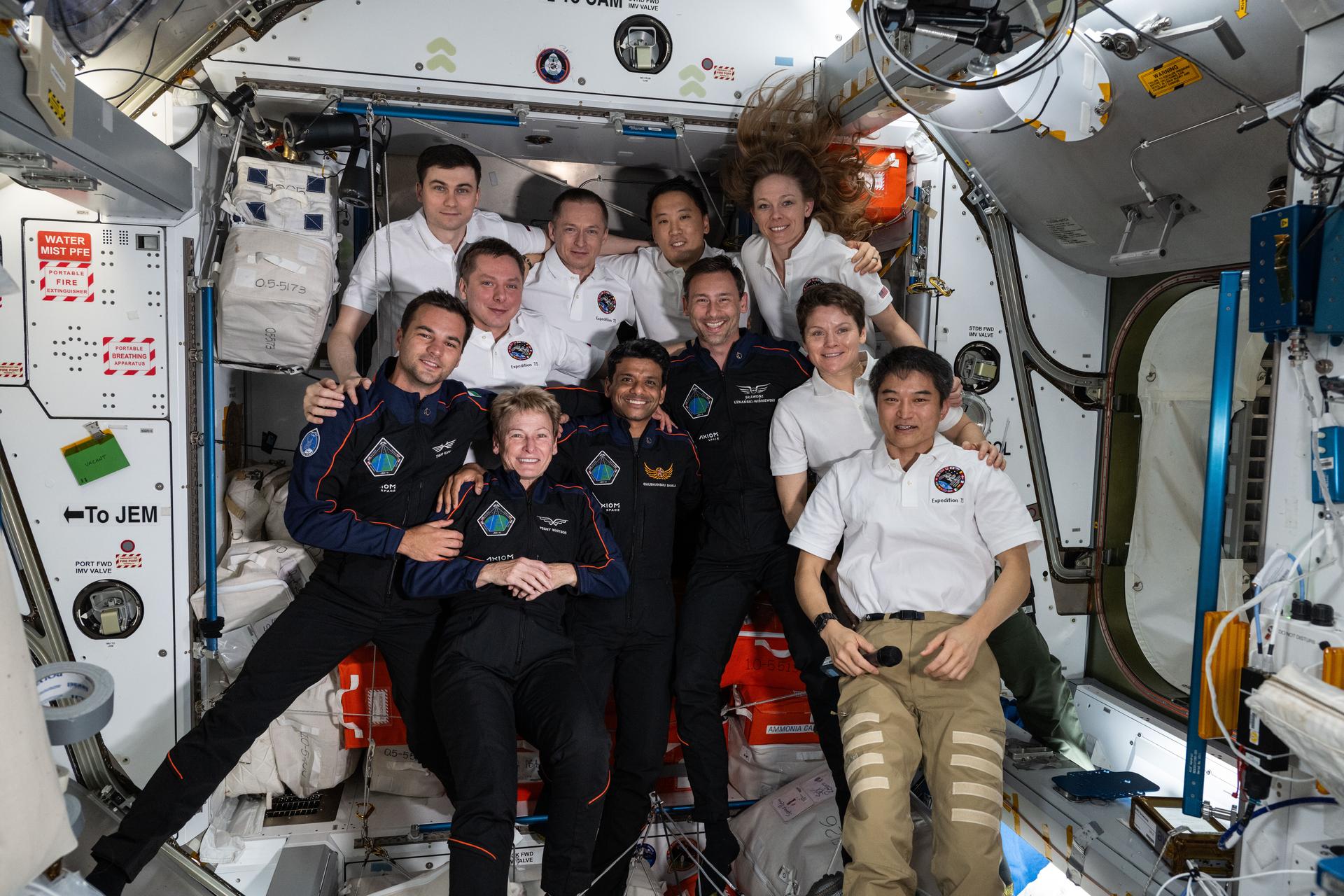 The Axiom Mission 4 (Ax-4) and Expedition 73 crews join each other for a group portrait inside the International Space Station's Harmony module. In the front row (from left) are, Ax-4 crewmates Tibor Kapu, Peggy Whitson, Shubhanshu Shukla, and Sławosz Uznański-Wiśniewski with Expedition 73 crewmates Anne McClain and Takuya Onishi. In the rear are, Expedition 73 crewmates Alexey Zubritskiy, Kirill Peskov, Sergey Ryzhikov, Jonny Kim, and Nichole Ayers.
