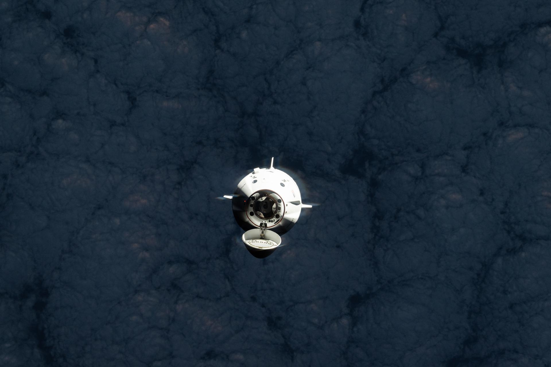 The SpaceX Dragon spacecraft carrying the Axiom Mission 4 (Ax-4) crew from Axiom Space approaches the International Space Station as both spacecraft were orbiting 269 miles above a cloudy southern Indian Ocean. Commanding Ax-4 inside Dragon was veteran astronaut Peggy Whitson leading Pilot Shubhanshu Shukla, and Mission Specialists Sławosz Uznański-Wiśniewski and Tibor Kapu. Dragon would dock later to the orbital outpost's space-facing port on the Harmony module.