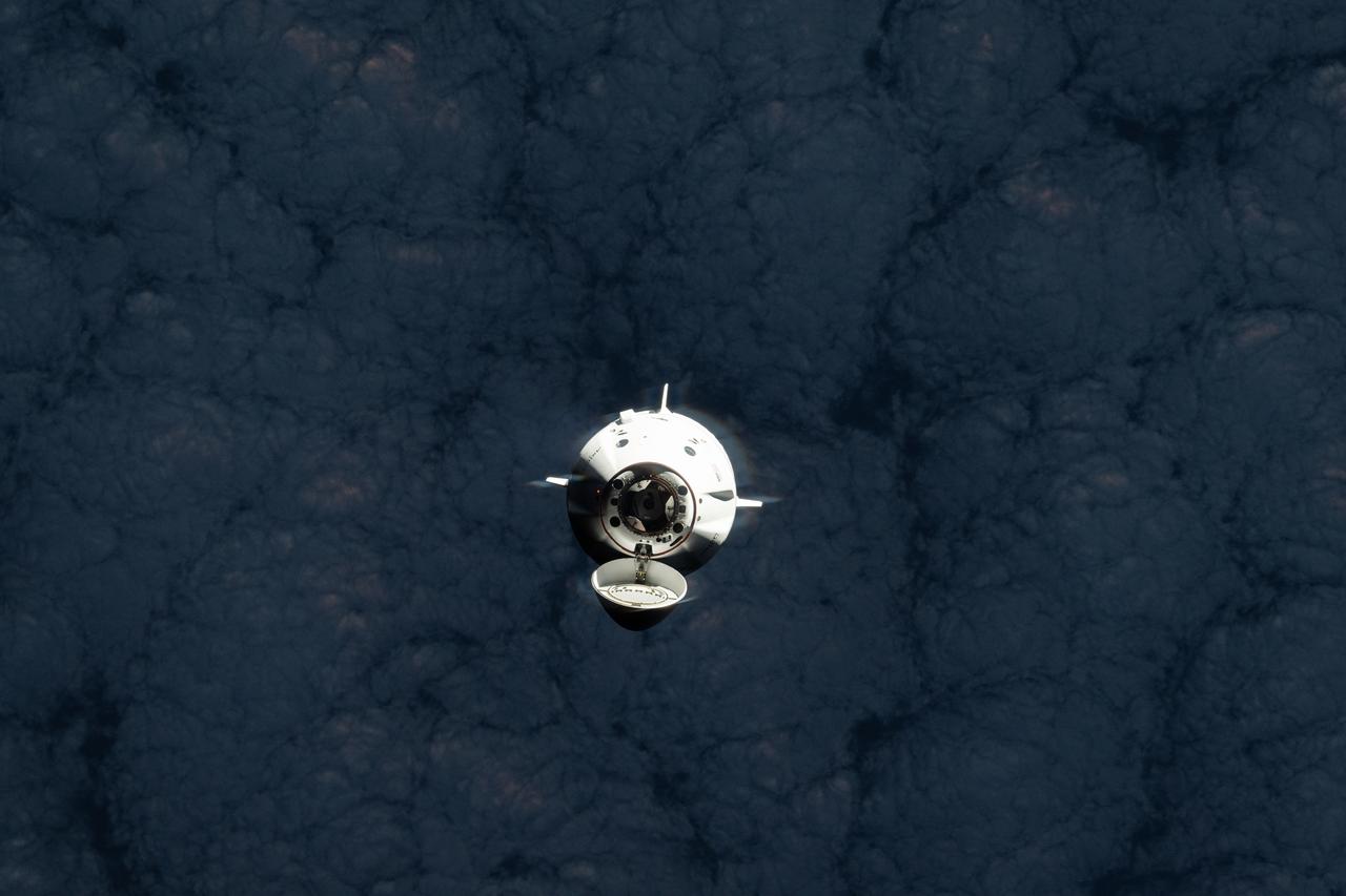 iss073e0249494 (June 26, 2025) --- The SpaceX Dragon spacecraft carrying the Axiom Mission 4 (Ax-4) crew from Axiom Space approaches the International Space Station as both spacecraft were orbiting 269 miles above a cloudy southern Indian Ocean. Commanding Ax-4 inside Dragon was veteran astronaut Peggy Whitson leading Pilot Shubhanshu Shukla, and Mission Specialists Sławosz Uznański-Wiśniewski and Tibor Kapu. Dragon would dock later to the orbital outpost's space-facing port on the Harmony module.