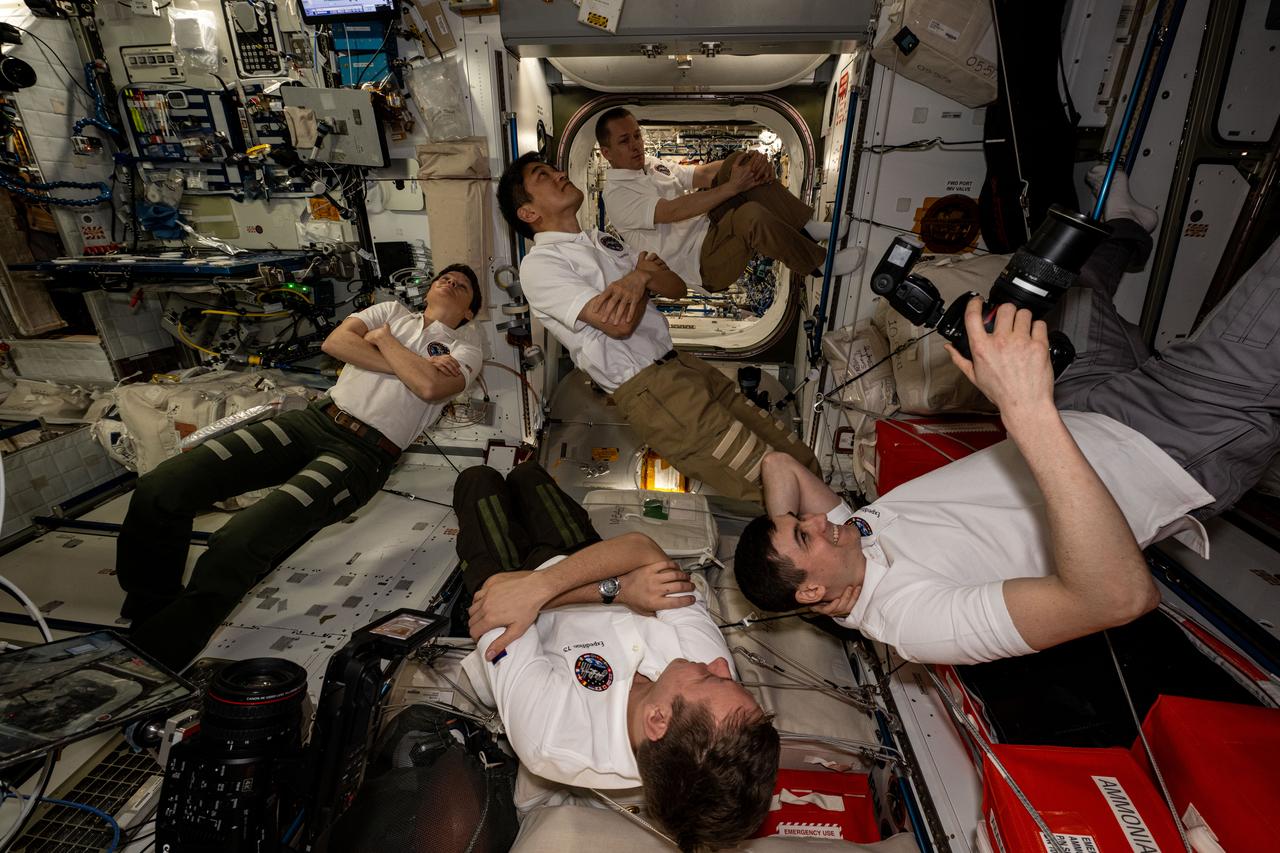 iss073e0251292 (June 26, 2025) --- Expedition 73 crew members patiently await the entrance of the Axiom Mission 4 crew from the SpaceX Dragon spacecraft into the International Space Station's Harmony module. Clockwise from left are, NASA Flight Engineer Anne McClain, JAXA (Japan Aerospace Exploration Agency) Commander Takuya Onishi, and Roscosmos Flight Engineers Sergey Ryzhikov, Alexander Zubritsky, and Kirill Peskov. Out of frame are, NASA Flight Engineers Nichole Ayers and Jonny Kim.