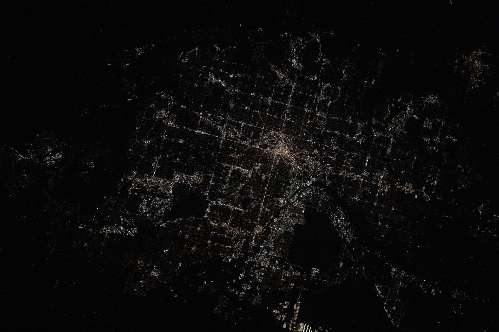 Denver, Colorado's capital and largest city with a metropolitan population of over 3 million, is pictured at approximately 2:42 a.m. local time from the International Space Station as it orbited 261 miles above the Centennial State.