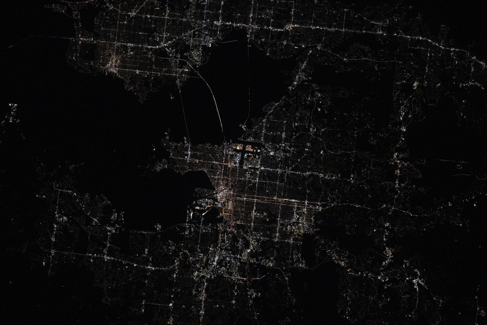 St. Petersburg (upper left) and Tampa (center), cities on Florida's Tampa Bay coast, are pictured at approximately 3:07 a.m. local time from the International Space Station as it orbited 260 miles above.