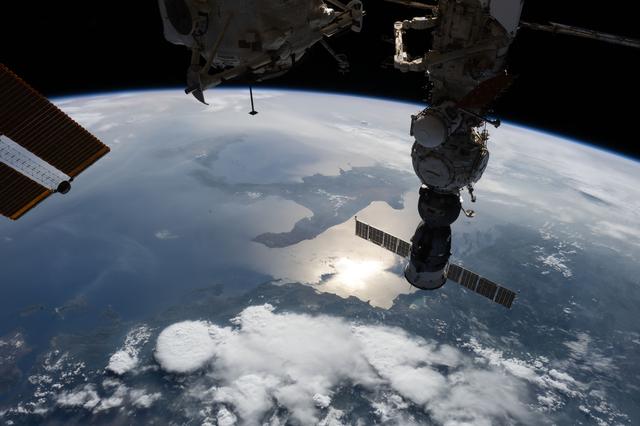 NASA image: The sun's glint beams off the Adriatic Sea contrasting with the "boot" of Italy