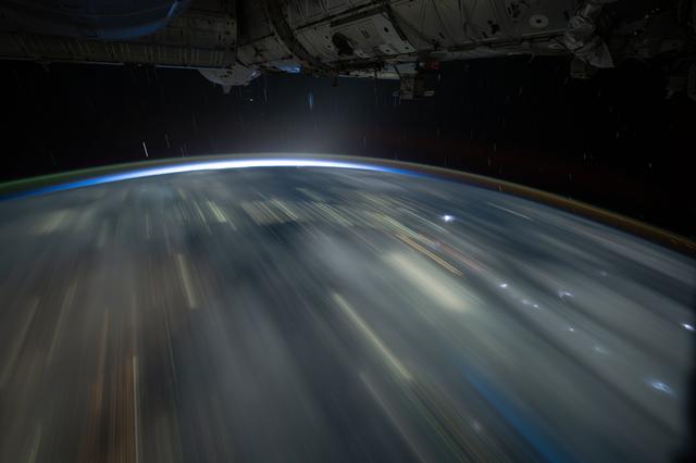 NASA image:  The city lights of Southeast Asia and lightning storms streak below the International Space Station