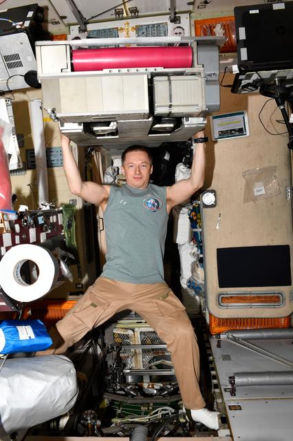 NASA image: Roscosmos cosmonaut Sergey Ryzhikov poses for a playful portrait in Zvezda service module