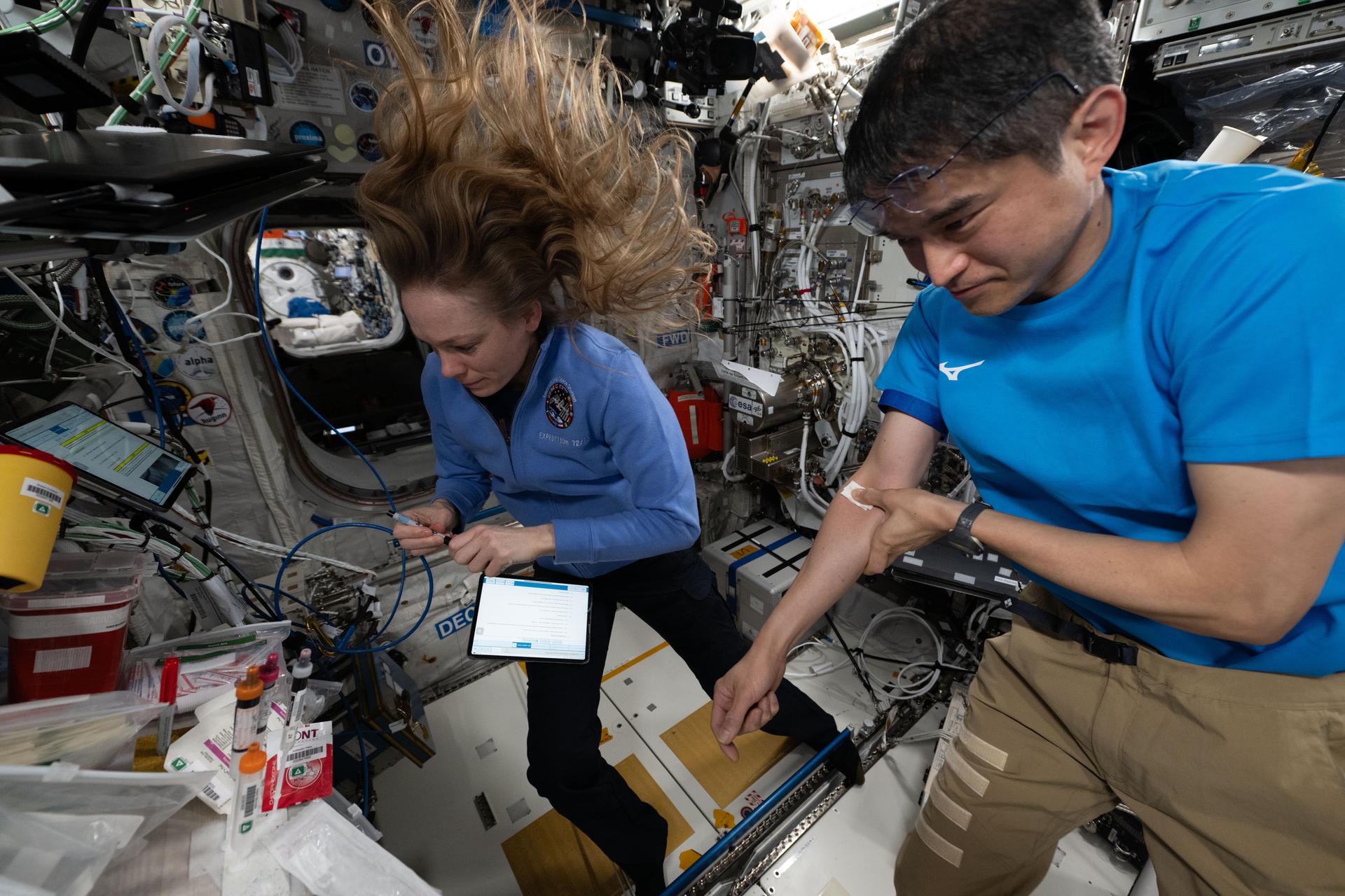 Expedition 73 Flight Engineer Nichole Ayers of NASA and International Space Station Commander Takuya Onishi of JAXA (Japan Aerospace Exploration Agency) collect blood samples for the Immunity Assay human research investigation. The study will analyze the blood samples for signs of space-caused stress on cellular immune function to help doctors monitor crew health and keeps crews healthy on long term space missions.