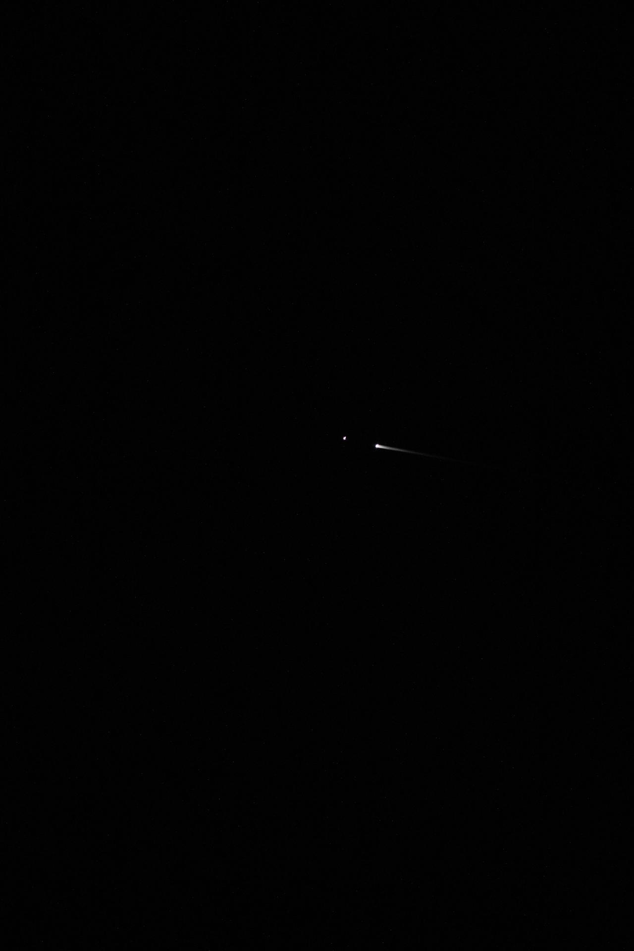 The SpaceX Dragon spacecraft carrying the Axiom Mission 4 crew is pictured from the International Space Station separating from its trunk and reentering Earth's atmosphere above the Pacific Ocean near the coast of California at approximately 12:20 a.m. local time. The streak is the plasma trail caused by the intense friction between Dragon's heat shield and the atmospheric gases as the spacecraft penetrates the atmosphere.