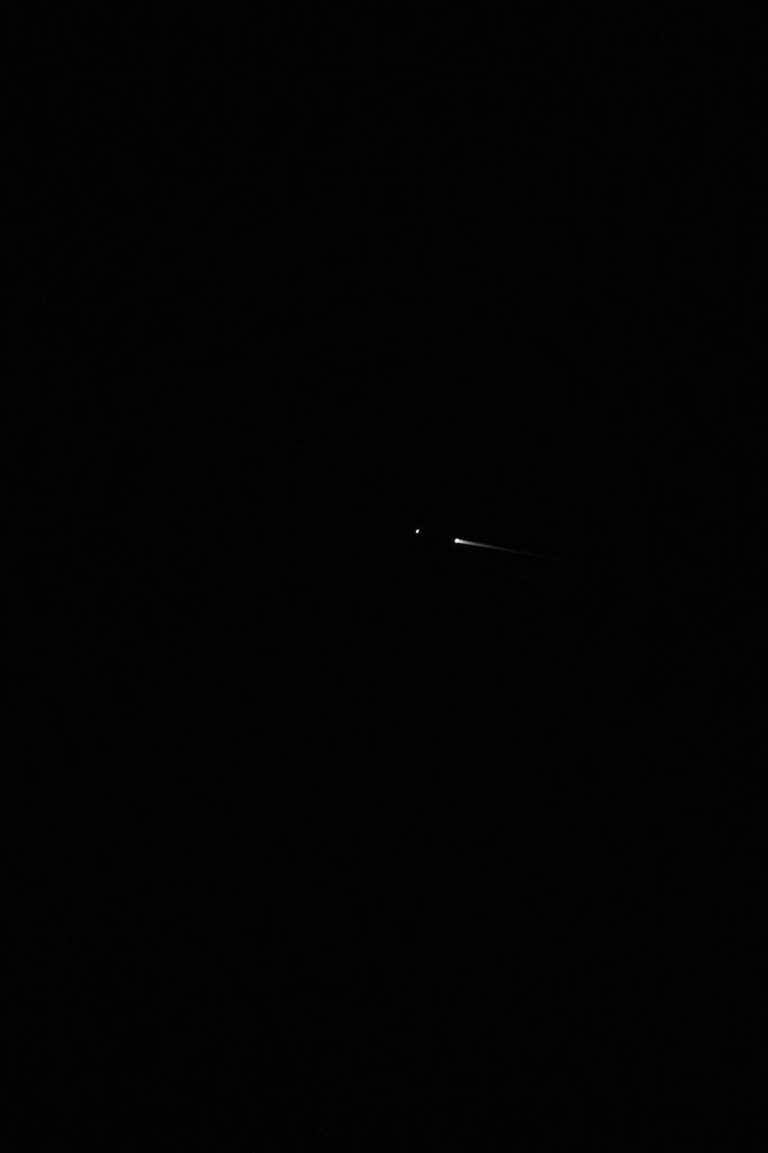 iss073e0343806 (July 15, 2025) --- The SpaceX Dragon spacecraft carrying the Axiom Mission 4 crew is pictured from the International Space Station separating from its trunk and reentering Earth's atmosphere above the Pacific Ocean near the coast of California at approximately 12:20 a.m. local time. The streak is the plasma trail caused by the intense friction between Dragon's heat shield and the atmospheric gases as the spacecraft penetrates the atmosphere.