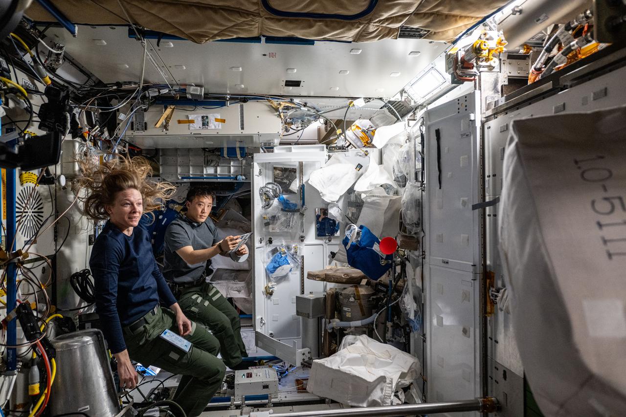 iss073e0379799 (July 21, 2025) --- Expedition 73 Flight Engineers Nichole Ayers and Jonny Kim, both NASA astronauts, work together inside the International Space Station's Tranquility module replacing electrical hardware that controls the distribution of power throughout the orbital outpost.