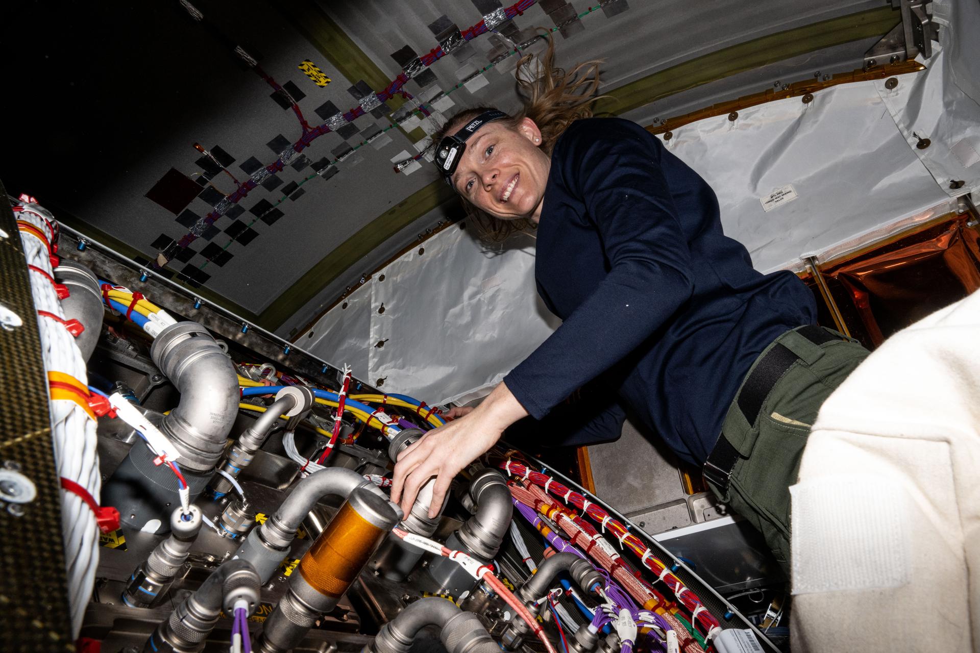 NASA astronaut and Expedition 73 Flight Engineer Nichole Ayers works inside the International Space Station's Tranquility module swapping out a remote power controller module and inspecting components on the Avionics Rack.