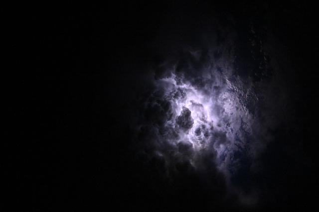 NASA image:  Lightning illuminates the cloud tops of Category 1 Hurricane Erick