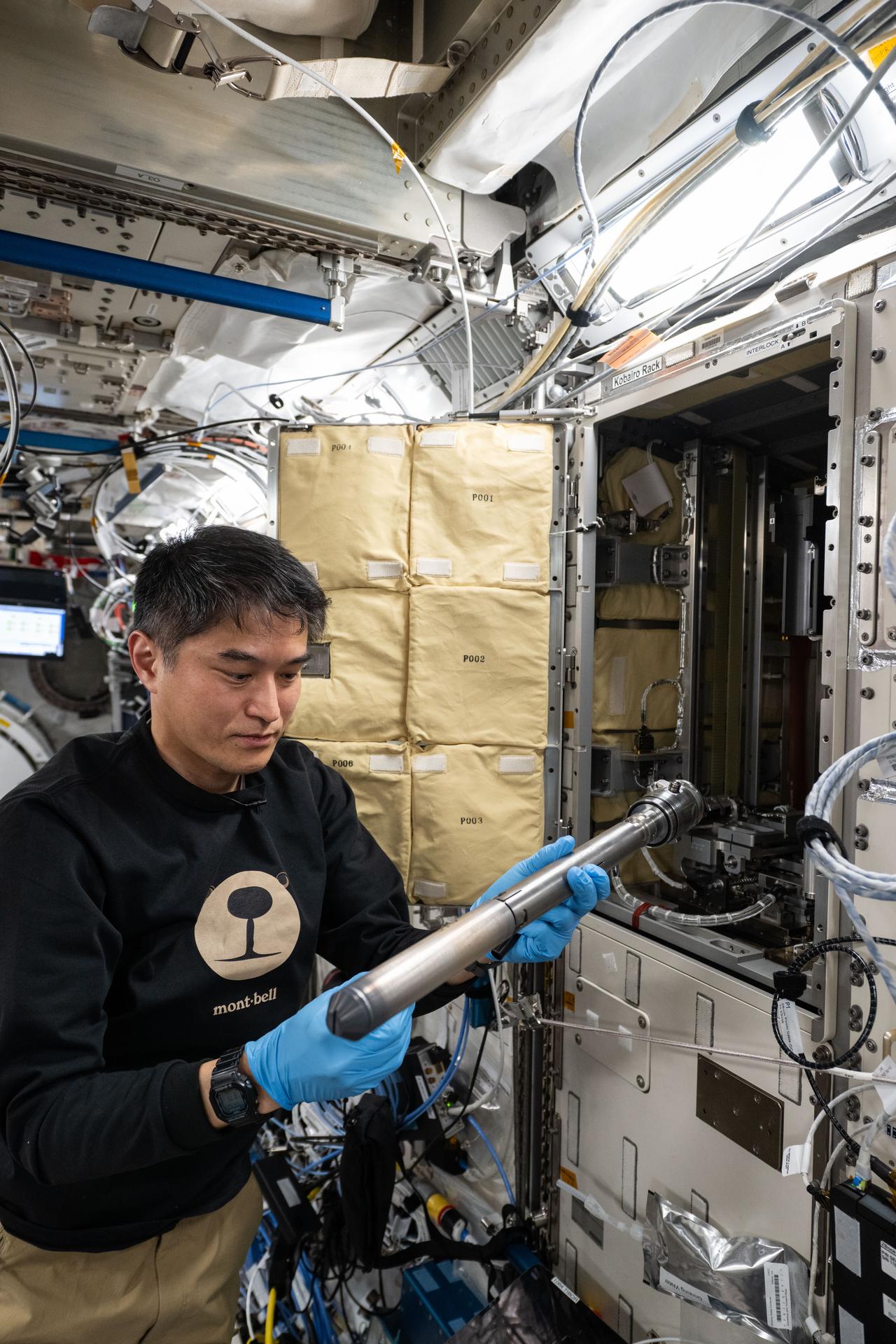 JAXA (Japan Aerospace Exploration Agency) astronaut and Expedition 73 Commander Takuya Onishi removes experiment hardware and sample cartridges from inside the Kibo laboratory module's Gradient Heating Furnace (GHF). The GHF is a research facility and a vacuum furnace that can safely heat samples up to a maximum temperature of 1,600 degrees Celsius and is used for the production of high quality crystals in new semiconductor materials.