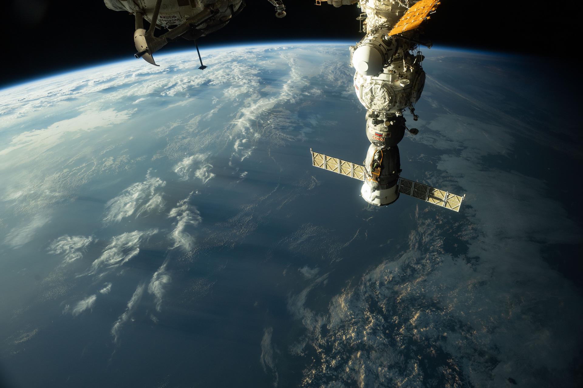 The sunset casts long, cloudy shadows over Japan in this photograph from the International Space Station as it orbited 259 miles above the island nation. In the right foreground, the Soyuz MS-27 crew ship is docked to the Prichal module.