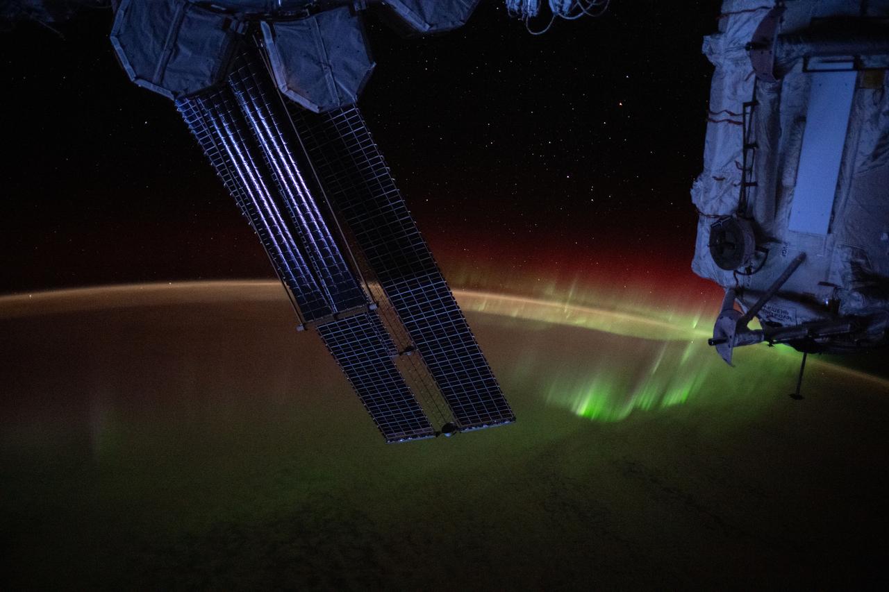 iss073e0384743 (July 22, 2025) --- A wispy aurora spikes across the Indian Ocean with a set of the International Space Station's main solar arrays (augmented by its rollout solar arrays) draping the foreground. At right, is the unoccupied Rassvet module that hosts visiting spacecraft from Roscosmos. The orbital outpost was soaring 270 miles above Earth southwest of Australia at the time of this photograph.