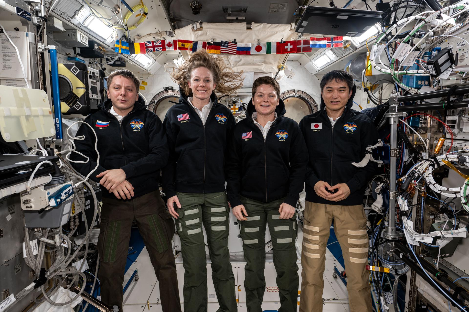 From left, NASA's SpaceX Crew-10 members Kirill Peskov of Roscosmos, NASA astronauts Nichole Ayers and Anne McClain, and JAXA (Japan Aerospace Exploration Agency) astronaut Takuya Onishi pose for a group portrait inside the International Space Station's Kibo laboratory module.