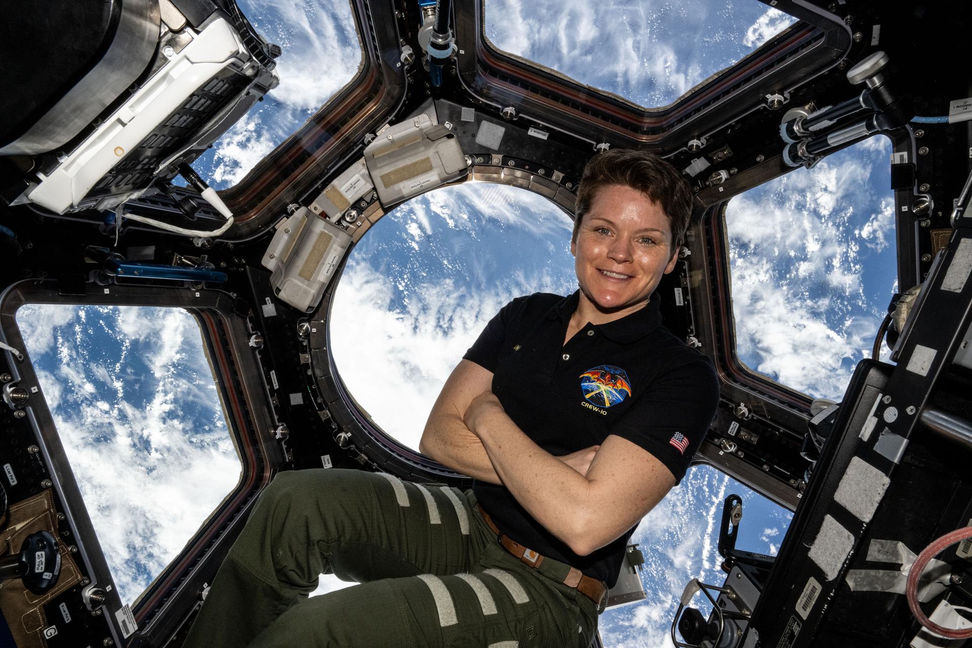 NASA astronaut and Expedition 73 Flight Engineer Anne McClain poses for a portrait inside the cupola, the International Space Station's "window to the world," as the orbital outpost soared 259 miles above the Atlantic Ocean west of the African island nation of Cabo Verde.