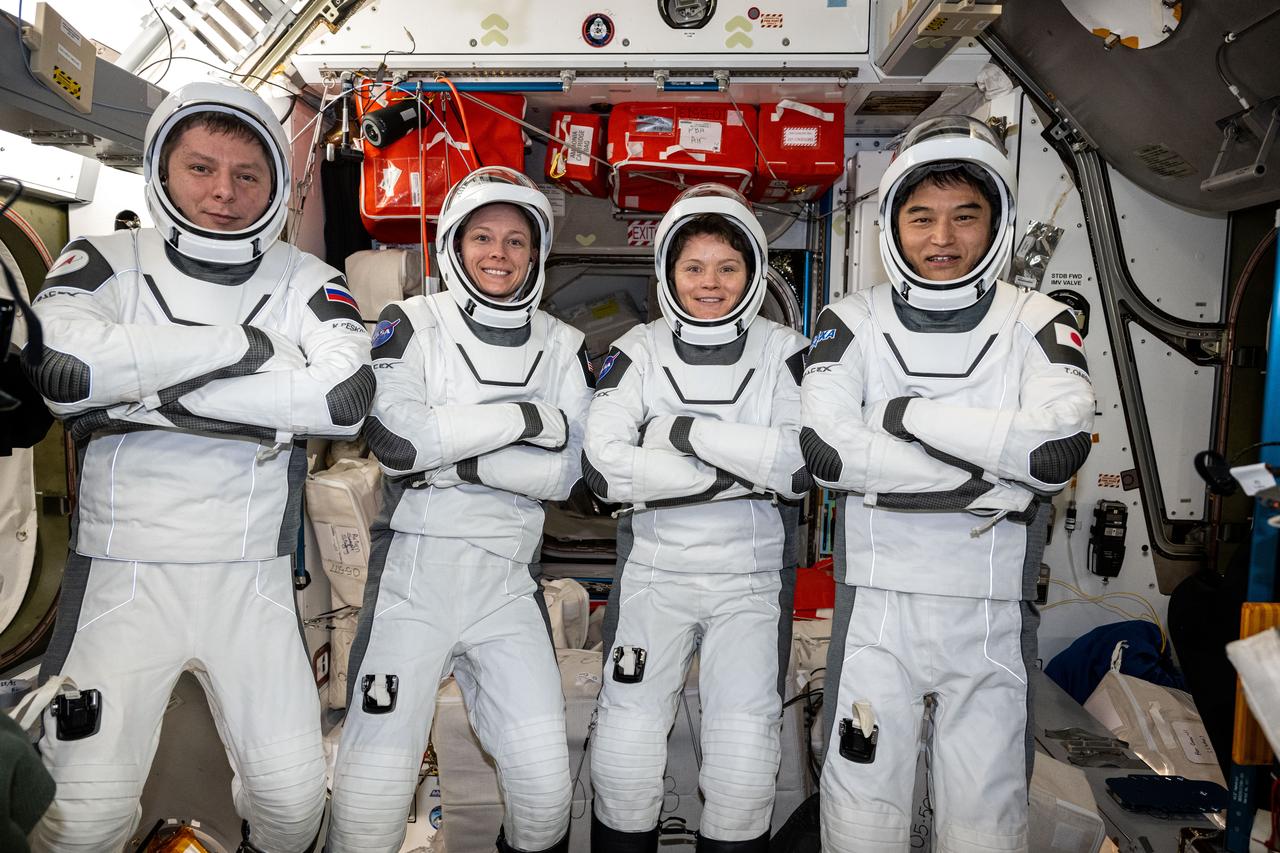 iss073e0414514 (July 29, 2025) --- The four members of NASA's SpaceX Crew-10 mission pose for a portrait in their Dragon pressure suits aboard the International Space Station's Harmony module. The Commercial Crew members were testing their suits' components and ensuring a proper fit before their departure on Aug. 8, 2025, aboard Dragon ending their five-month space research mission inside the orbital outpost. From left are, Roscosmos cosmonaut Kirill Peskov, NASA astronauts Nichole Ayers and Anne McClain, and JAXA (Japan Aerospace Exploration Agency) astronaut Takuya Onishi.