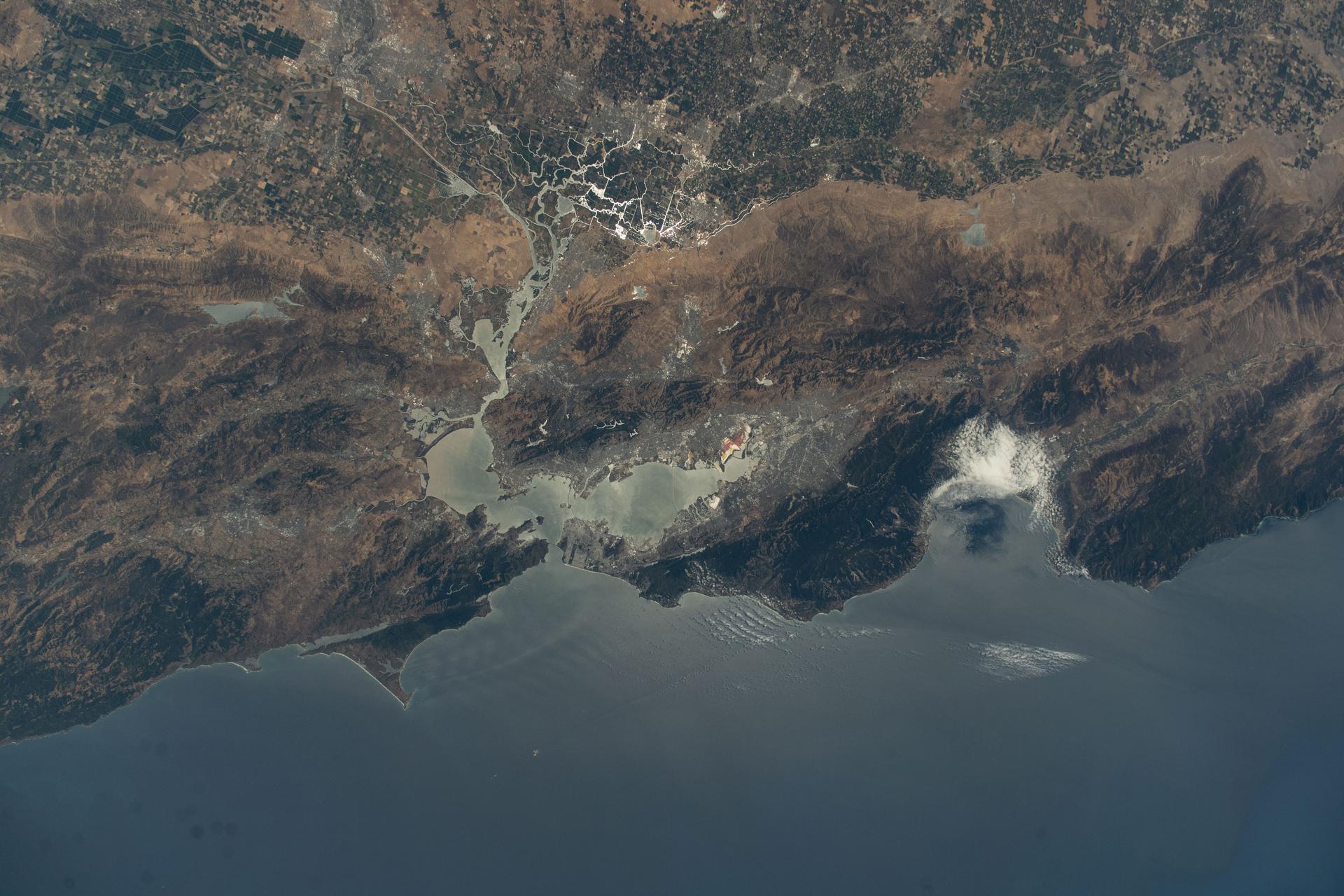 California's San Francisco Bay Area surrounded by the cities of San Francisico, Oakland, and San Jose, is pictured from the International Space Station as it orbited 260 miles above the Golden State. At top, the sun's glint beams off the San Joaquin River in California's Central Valley.