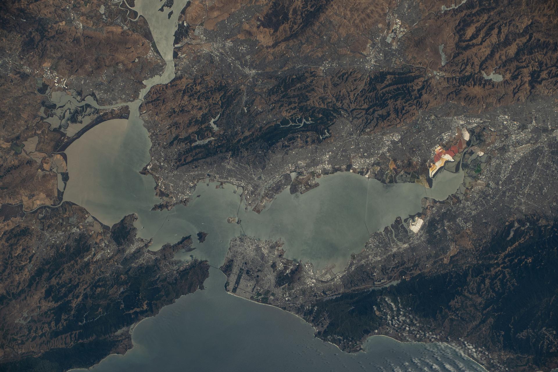 California's San Francisco Bay Area surrounded by the cities of San Francisico, Oakland, and San Jose, and their suburbs, is pictured from the International Space Station as it orbited 260 miles above the Golden State. Visible landmarks include the Golden Gate Bridge and the Don Edwards San Francisco Bay National Wildlife Refuge.