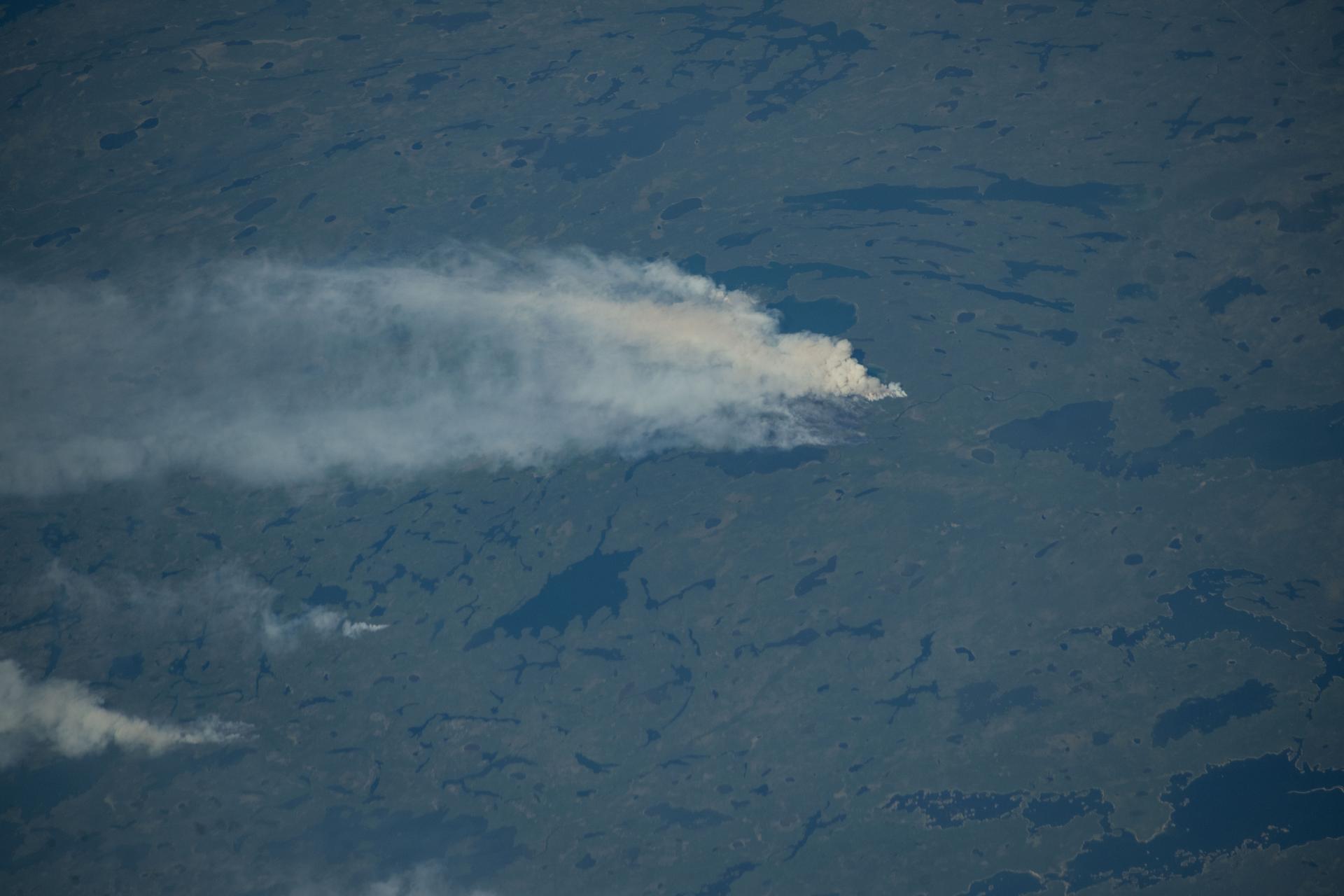 Wildfires burn throughout Canada's central provinces sending smoke drifitng into the United States' Great Lakes and Northeast regions impacting air quality. The International Space Station was orbiting 262 miles above Canada at the time of this photograph.