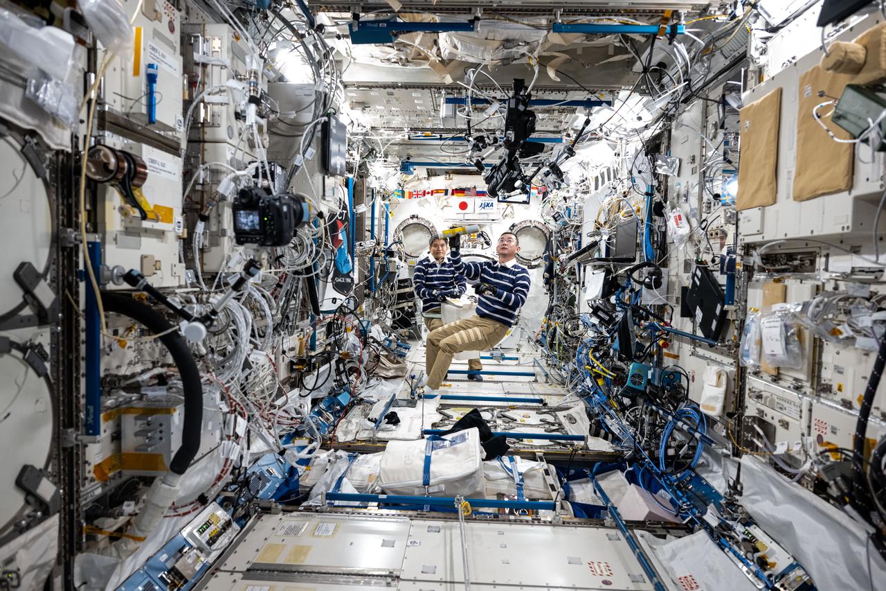 iss073e0420867 (Aug. 2, 2025) --- From left, JAXA (Japan Aerospace Exploration Agency) astronauts Takuya Onishi and Kimiya Yui, Expedition 73 Commander and Flight Engineer respectively, are pictured during crew familiarization activities inside the International Space Station's Kibo laboratory module. 