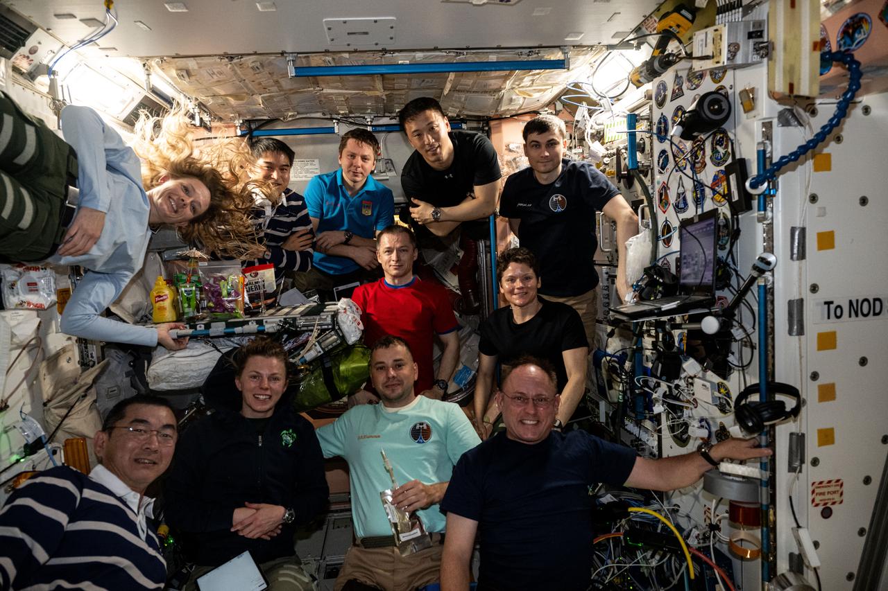 iss073e0420899 (Aug. 3, 2025) --- Eleven International Space Station crew members gather inside the International Space Station's Unity module for a portrait. In the front row, from left are, Kimiya Yui of JAXA (Japan Aerospace Exploration Agency), Zena Cardman of NASA, Oleg Platonov of Roscosmos, and Mike Fincke of NASA. In the second row are, Nichole Ayers of NASA, Sergey Ryzhikov of Roscosmos, and Anne McClain of NASA. In the back are, Takuya Onishi of JAXA, Kirill Peskov of Roscosmos, Jonny Kim of NASA, and Alexey Zubritsky of Roscosmos.