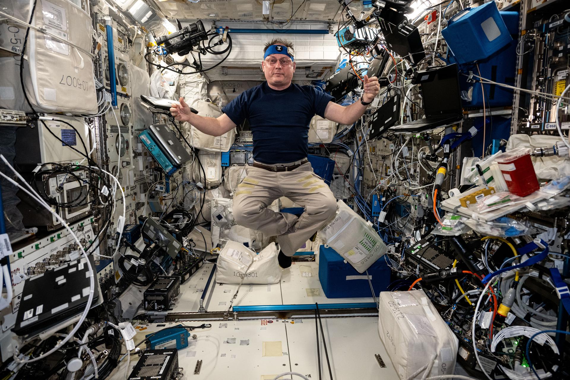NASA astronaut and Expedition 73 Flight Engineer Mike Fincke poses for a portrait inside the International Space Station's Columbus laboratory module during research operations to learn how the body maintains its core temperature in microgravity.