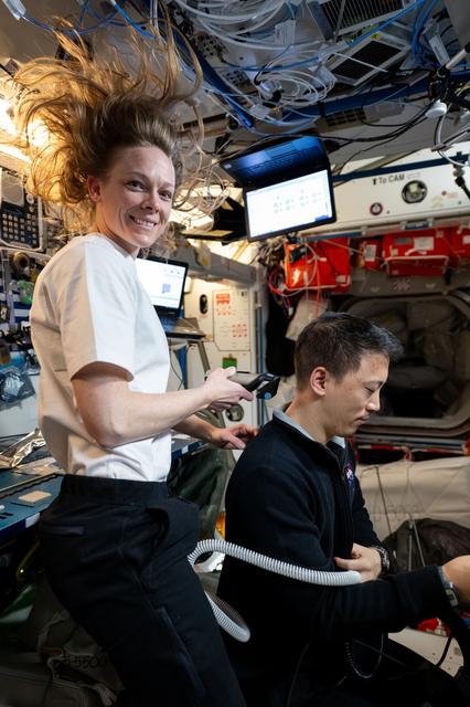 NASA image: Nichole Ayers trims Jonny Kim's hair aboard the International Space Station