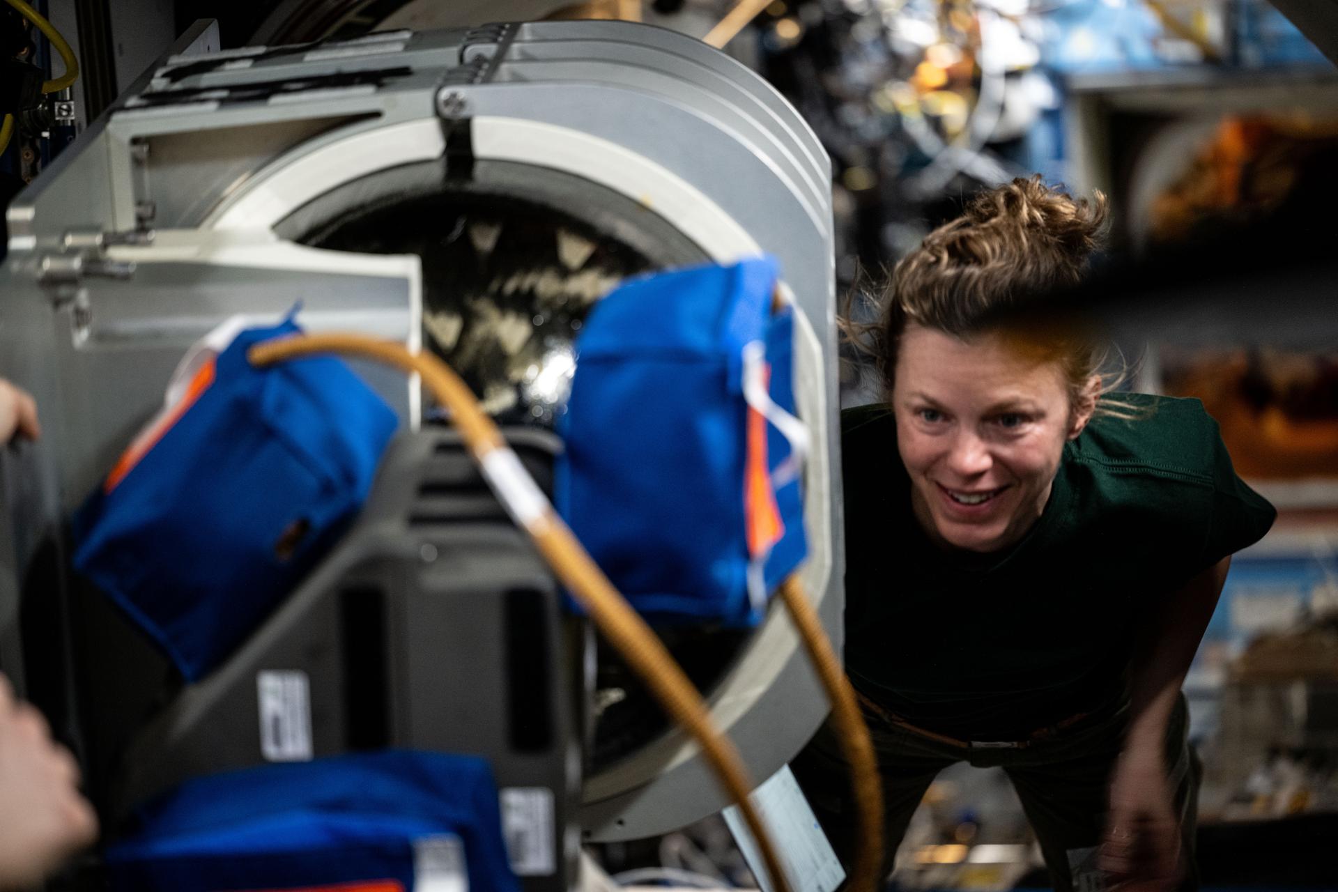 NASA astronaut and Expedition 73 Flight Engineer Zena Cardman transfers emergency hardware from the International Space Station into the SpaceX Dragon crew spacecraft as part of standard operations.