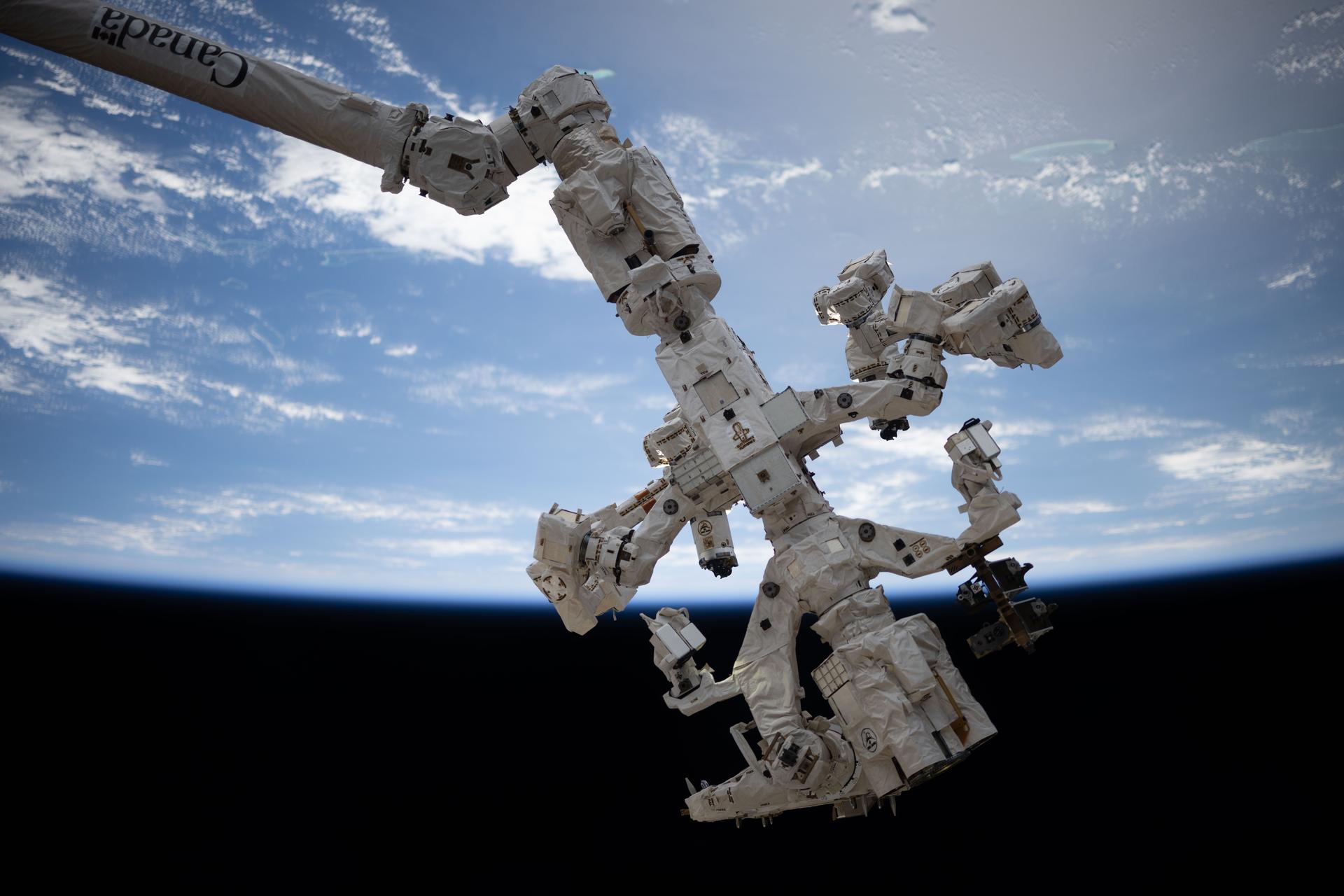 The Special Purpose Dexterous Manipulator, also known as Dextre, the International Space Station's fine-tuned robotic hand, is pictured attached to the Canadarm2 robotic arm as the orbital outpost soared 263 miles above the South Pacific Ocean. Dextre performs precise maintenance capabilities on the space station, including removing and replacing small parts and performing photographic inspections, reducing the need for time-intensive spacewalks.