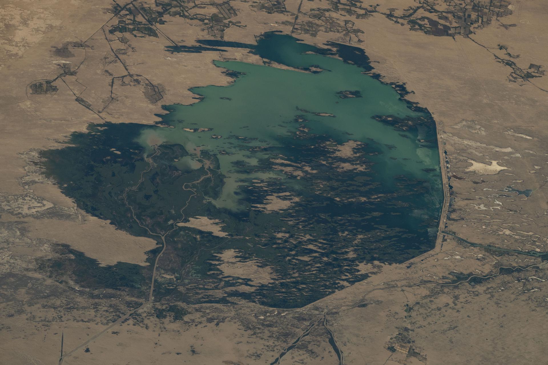 The Zeid Reservoir in Turkmenistan is pictured from the International Space Station as it orbited 260 miles above Central Asia. The reservoir was designed to capture some of the sand and sediment flowing in from the nearby Amu Darya River and the Karakum Canal. This helps keep the water cleaner and protects the canal system from getting clogged.