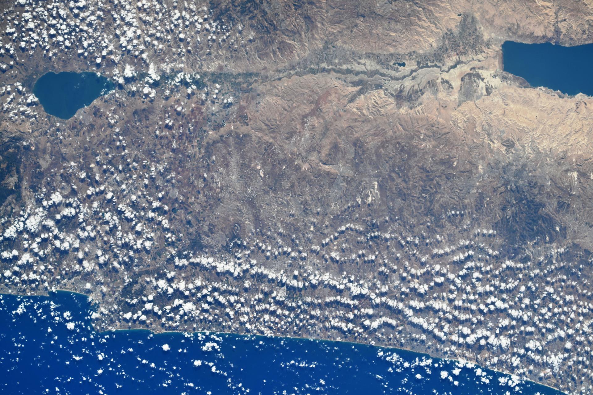From left to right, the Sea of Galilee—the world’s lowest freshwater lake—and the Dead Sea—the lowest saltwater lake—are connected by the Jordan River in Israel. At the bottom of the image, the Mediterranean coastline is visible from the International Space Station as it orbited 260 miles above Earth. Credit: Roscosmos