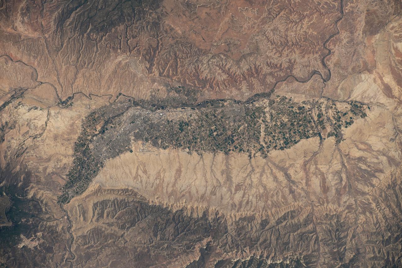 iss073e0429954 (June 21, 2025) --- Colorado's Western Slope region, highlighted by the city of Grand Junction and its surrounding suburbs (at center), is pictured from the International Space Station as it orbited 261 miles above the Centennial State. The municipality's economy is primarily supported by the agribusiness industry, including cattle ranching and fruit cultivation.