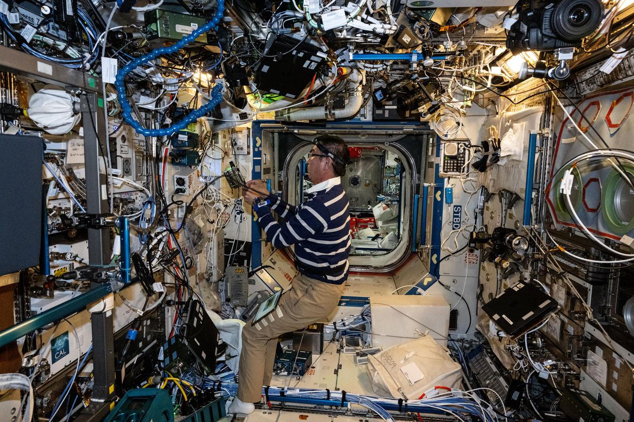 iss073e0431947 (Aug. 12, 2025) --- JAXA (Japan Aerospace Exploration Agency) astronaut and Expedition 73 Flight Engineer Kimiya Yui works on the Cold Atom Lab inside the International Space Station’s Destiny laboratory module. He replaced computer components in the physics research device, which chills atoms to temperatures below the average temperature of the universe enabling scientists to observe atomic wave functions and quantum behaviors not possible on Earth.