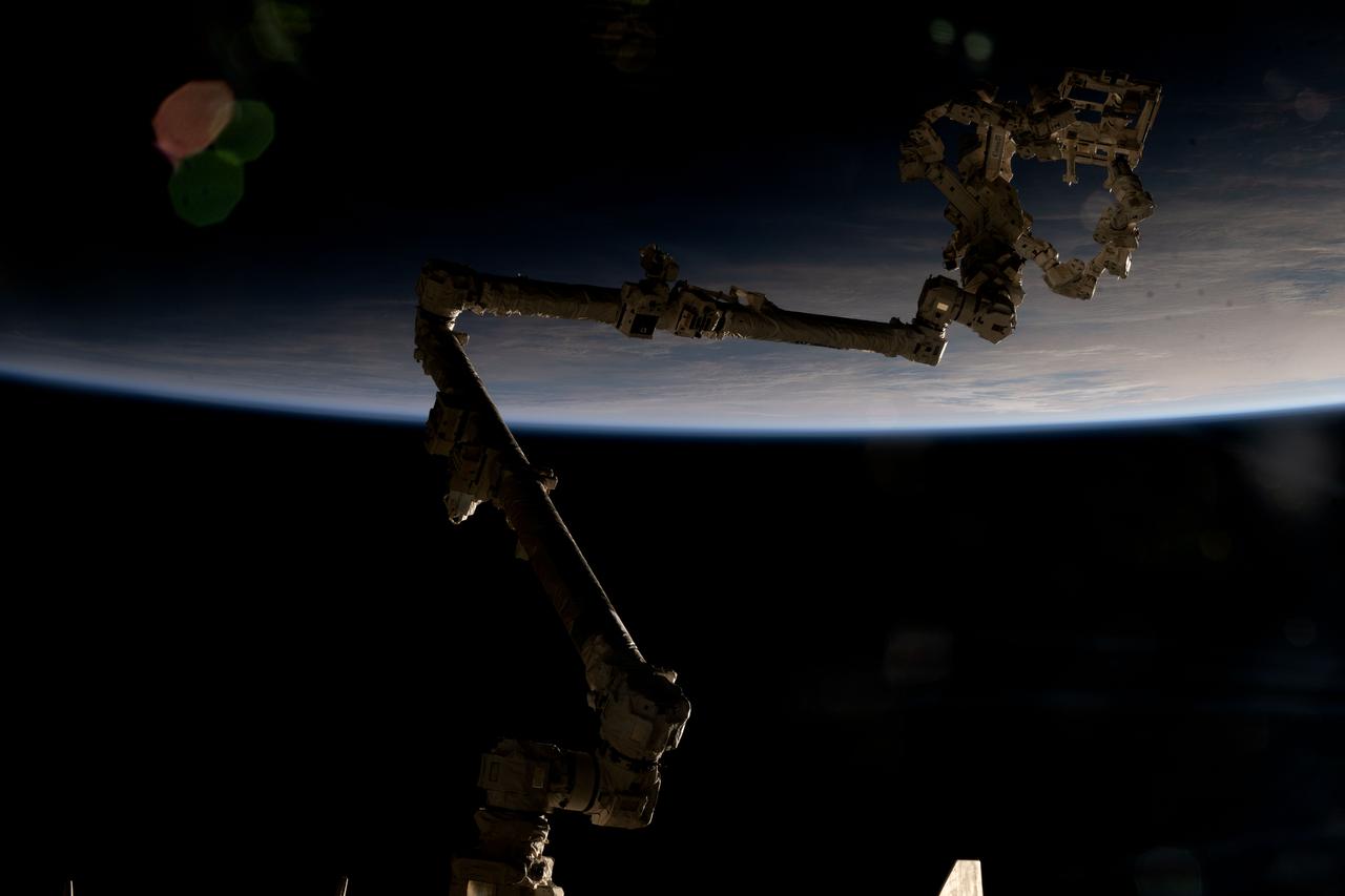 iss073e0490038 (July 22, 2025) --- The International Space Station's 57.7-foot-long robotic arm, also known as the Canadarm2, is partially silhouetted against an orbital sunrise 271 miles above the Indian Ocean south of Australia's island state of Tasmania. Attached to the Canadarm2's latching end effector is Dextre (top right), the fine-tuned robotic hand that performs precise maintenance capabilities on the orbital outpost, including removing and replacing small parts and performing photographic inspections, reducing the need for time-intensive spacewalks.
