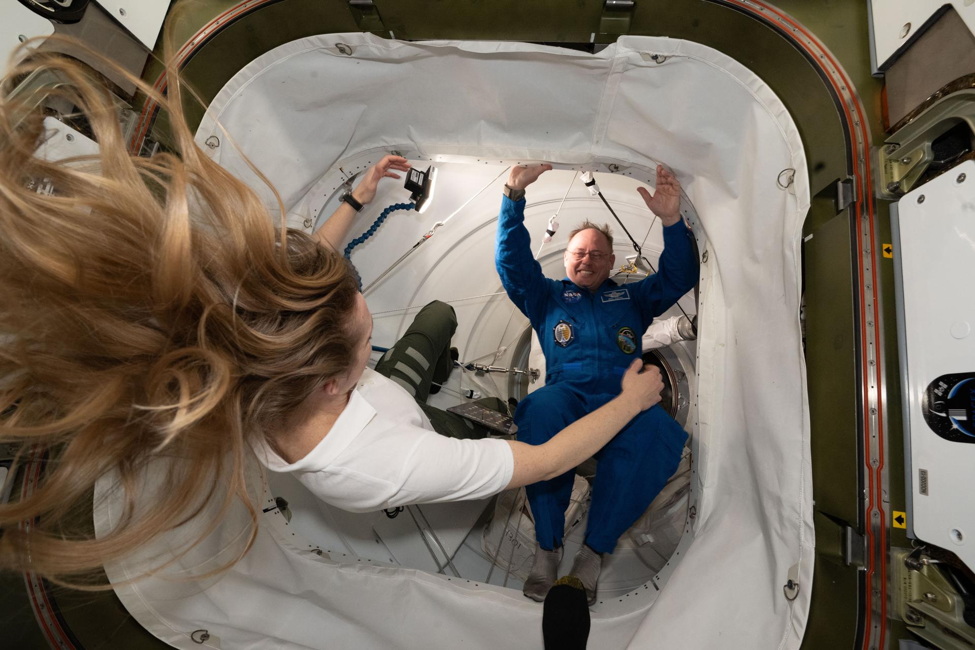 NASA's SpaceX Crew-11 Pilot Mike Fincke is welcomed aboard the International Space Station by Expedition 73 Flight Engineer Nichole Ayers of NASA after the Dragon crew spaceraft docked to the Harmony module's space-facing port.