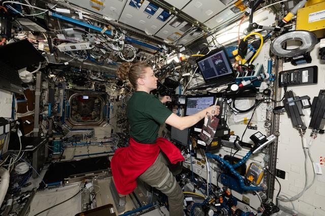 NASA image: NASA astronaut Zena Cardman operates the robotics workstation for a computerized test
