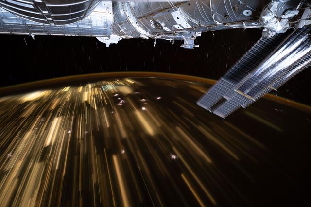 NASA image: The warm city lights of Southeast Asia streak below the International Space Station