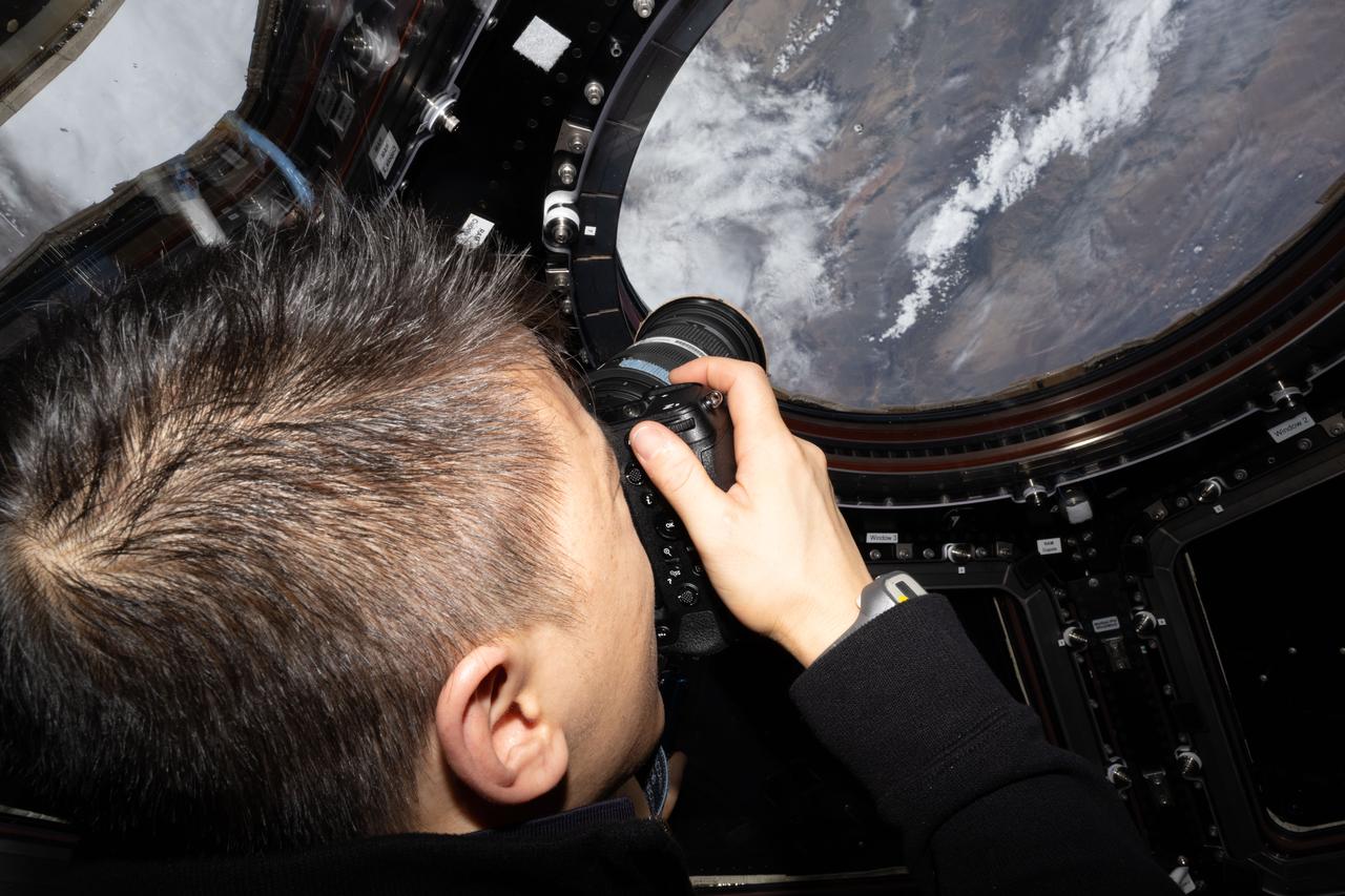 iss073e0508025 (Aug. 2, 2025) --- NASA astronaut and Expedition 73 Flight Engineer Jonny Kim points his camera out a window on the International Space Station's cupola and photographs Earth landmarks below as the orbital outpost soared 261 miles above central Mongolia.