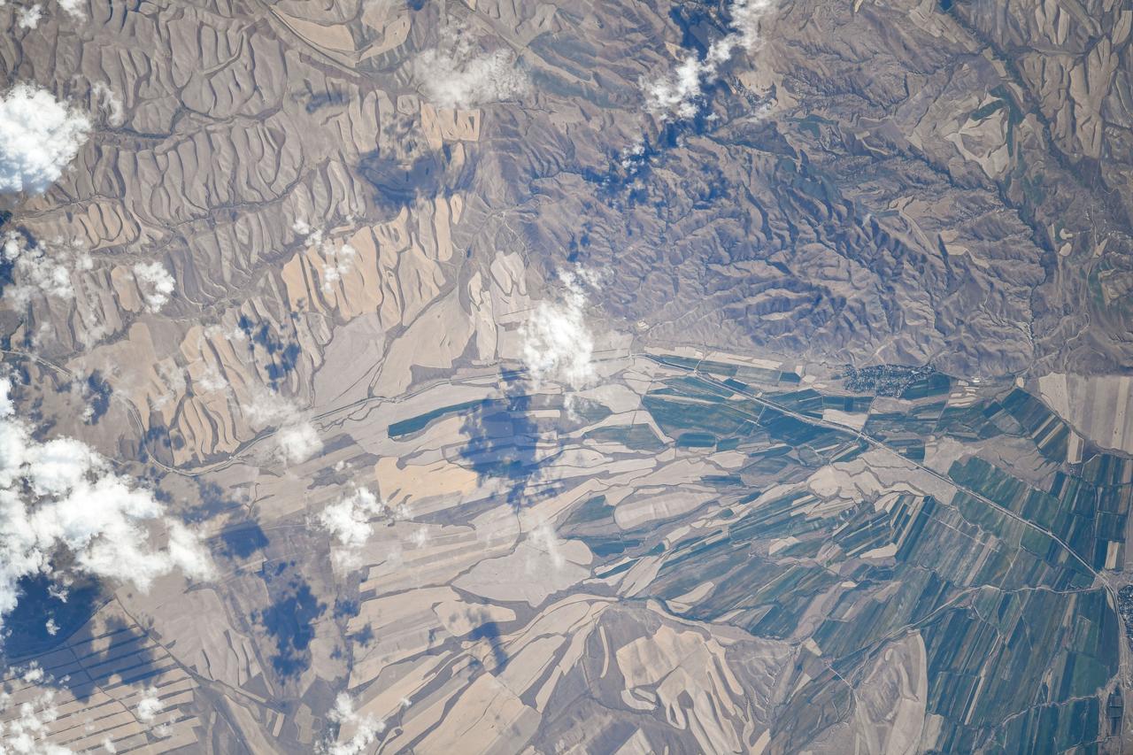 iss073e0510447 (Aug. 19, 2025) --- Agricultural activities in the diverse landscape of Kazakhstan's Jetisu region, near the Chinese border and once a key corridor of the ancient Silk Road, are pictured from the International Space Station as it orbited 263 miles above the Central Asian nation. Credit: Roscosmos
