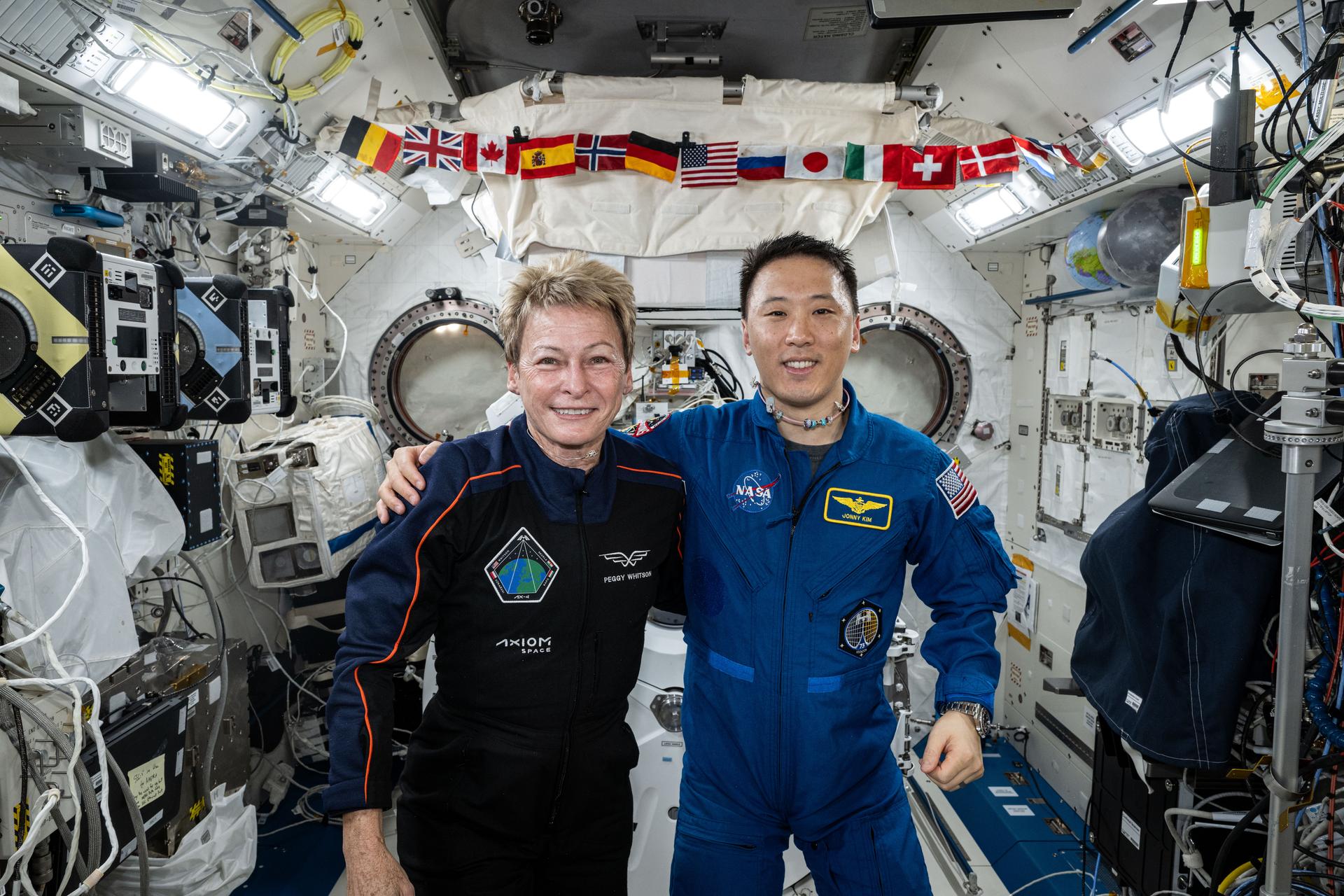 Axiom Mission 4 Commander Peggy Whitson and Expedition 73 Flight Engineer Jonny Kim from NASA pose together for portrait taken inside the International Space Station's Kibo laboratory module.