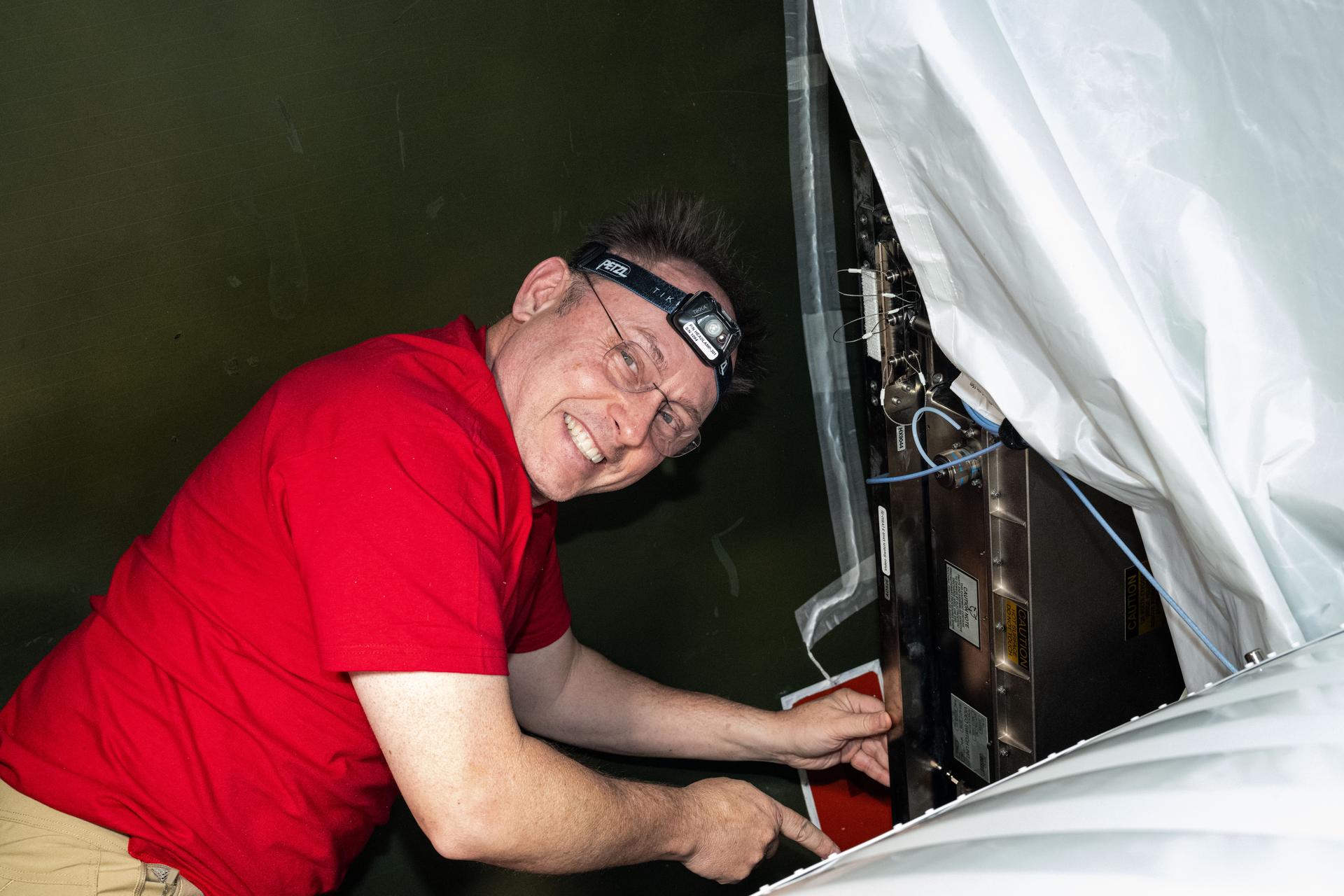 NASA astronaut and Expedition 73 Flight Engineer Mike Fincke is pictured during communications maintenance activities aboard the International Space Station's Destiny laboratory module.