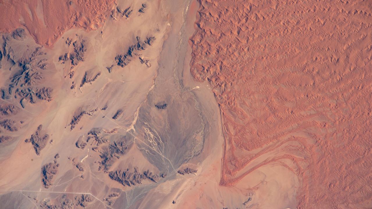 iss073e0511487 (Aug. 20, 2025) --- A portion of the hot, arid Namib Desert near the Atlantic coast, with its sand dunes created by strong onshore winds close to the NamibRand Nature Reserve, is pictured from the International Space Station as it orbited 262 miles above Namibia.