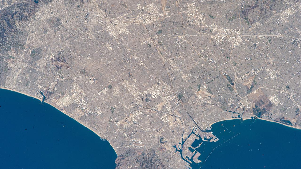 iss073e0513936 (Aug. 22, 2025) --- Los Angeles, California, surrounded by its suburbs including Santa Monica, Marina Del Rey, and Long Beach, is pictured from the International Space Station as it orbited 261 miles above the Golden State. Highlights include Terminal Island (bottom right), an artificial island used mainly for industrial and port-related activities. At left, near Marina Del Rey is Los Angeles International Airport (LAX) connecting over 80 million passengers annually to over 100 domestic and international destinations.