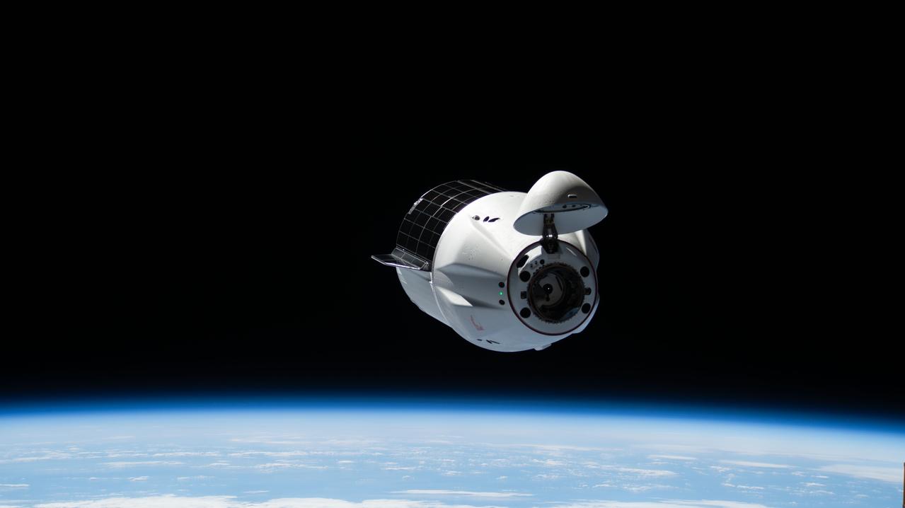 iss073e0519825 (Aug. 25, 2025) --- A SpaceX Dragon cargo spacecraft with its nosecone open and carrying over 5,000 pounds of science, supplies, and hardware for NASA's SpaceX CRS-33 mission approaches the International Space Station for an automated docking to the Harmony module's forward port. Both spacecraft were flying 262 miles above the Atlantic Ocean east of the Canadian province of Newfoundland at the time of this photograph.