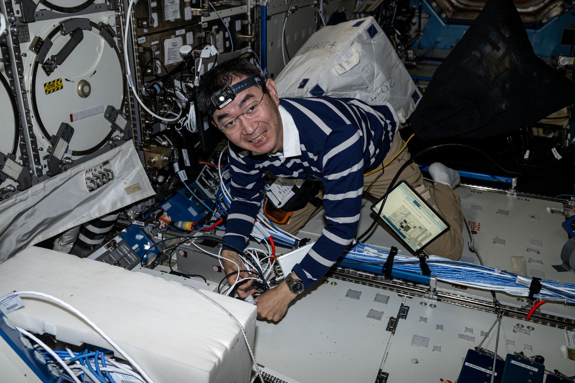 Expedition 73 Flight Engineer Kimiya Yui of JAXA (Japan Aerospace Exploration Agency) unpacks some of the science, supplies, and hardware delivered aboard the SpaceX Dragon cargo spacecraft and begins installing the new gear inside the International Space Station.